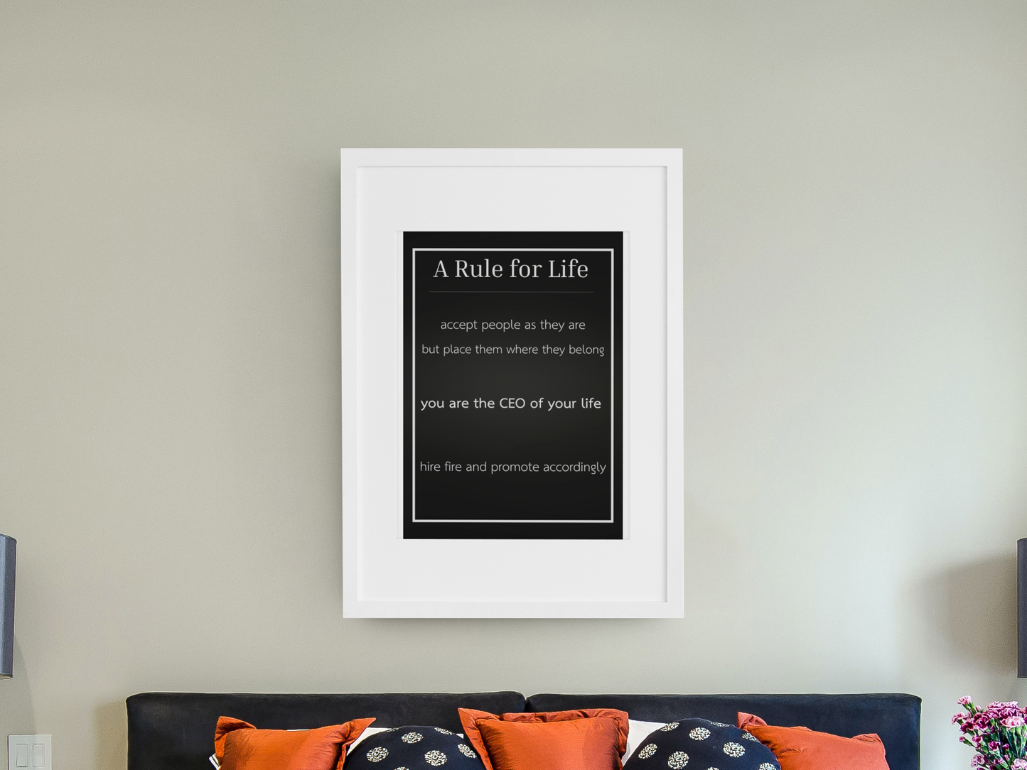 Framed print with 'A Rule for Life' quote on a wall above a bed.