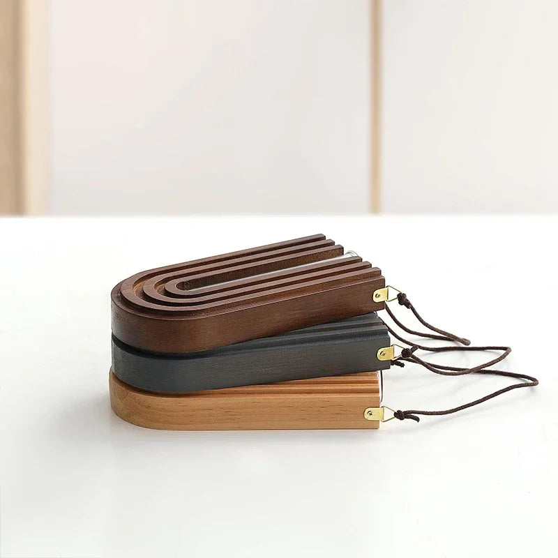 Set of wooden and metal belts on a white surface with a neutral background