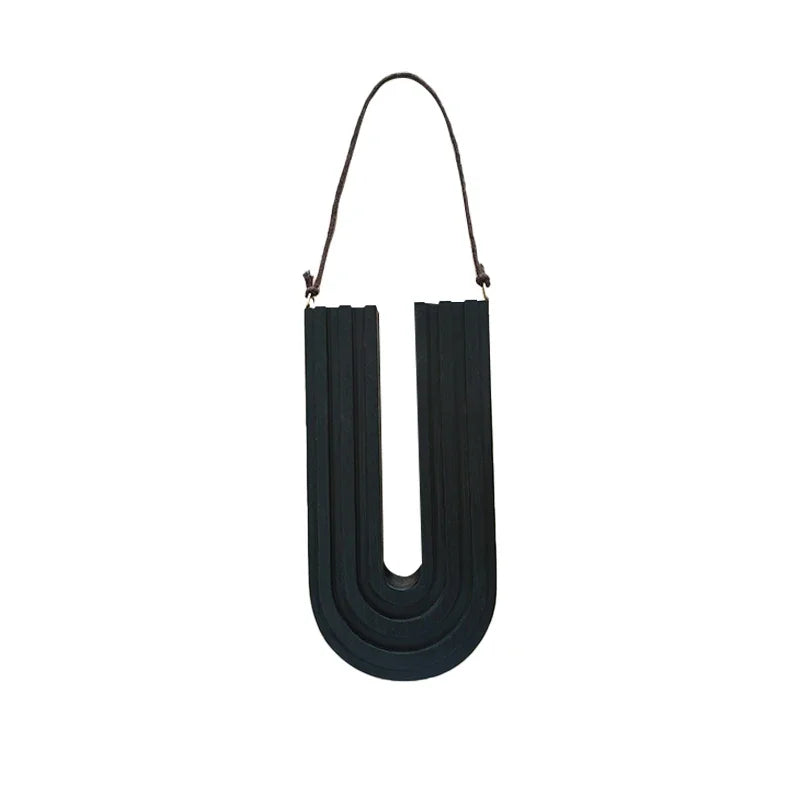 Black U-shaped object with a strap on a white background