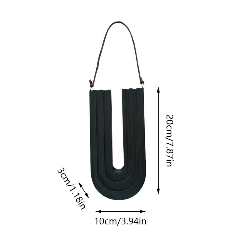 Black U-shaped object with measurements on a white background