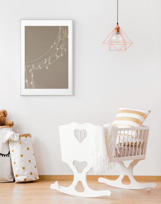 Nursery room with rocking chair, crib, and Celestial Moon and Stars Wall Art on a white wall.