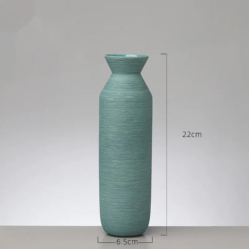 Green textured vase with dimensions on a gray background