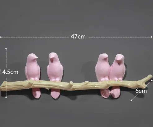 Two sets of pink bird figurines on a branch with measurements indicated.