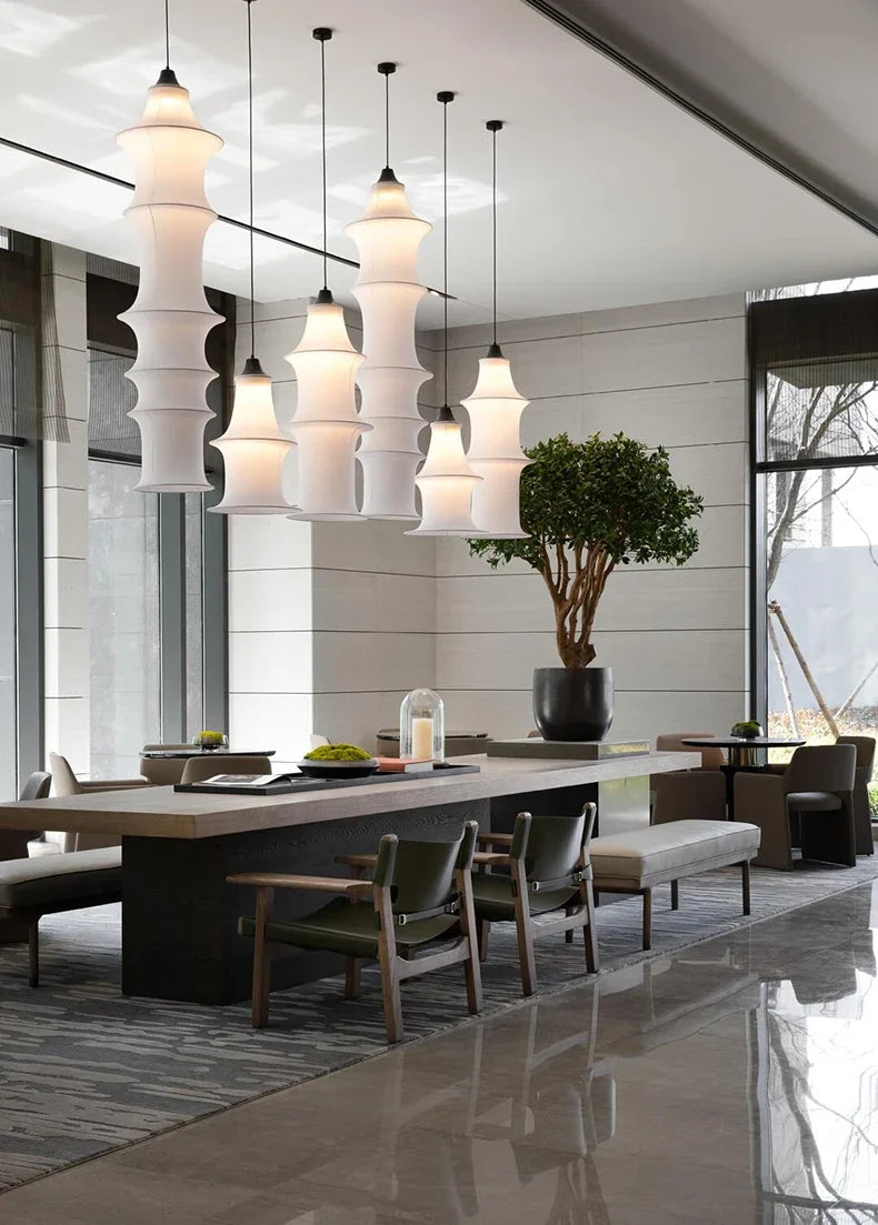 Modern interior with pendant lights, a dining table, and chairs.