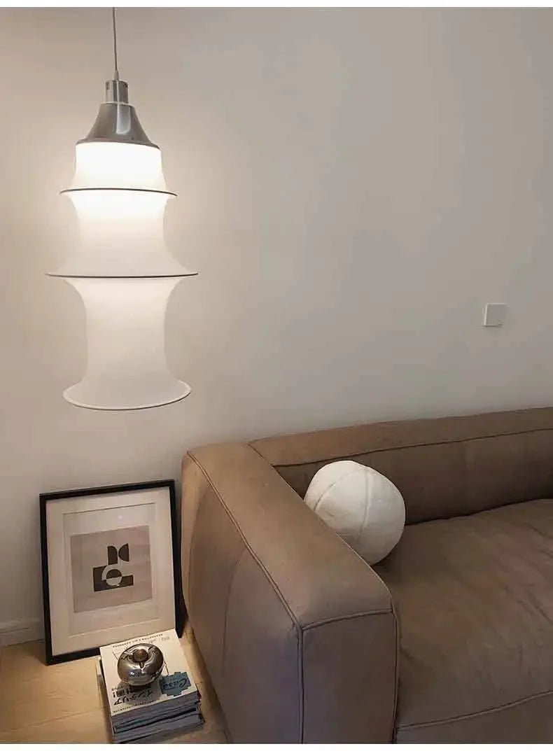 Modern pendant light hanging above a sofa in a living room setting.