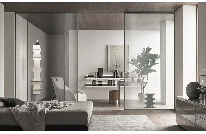 Modern bedroom with sliding glass doors leading to a sunlit room.