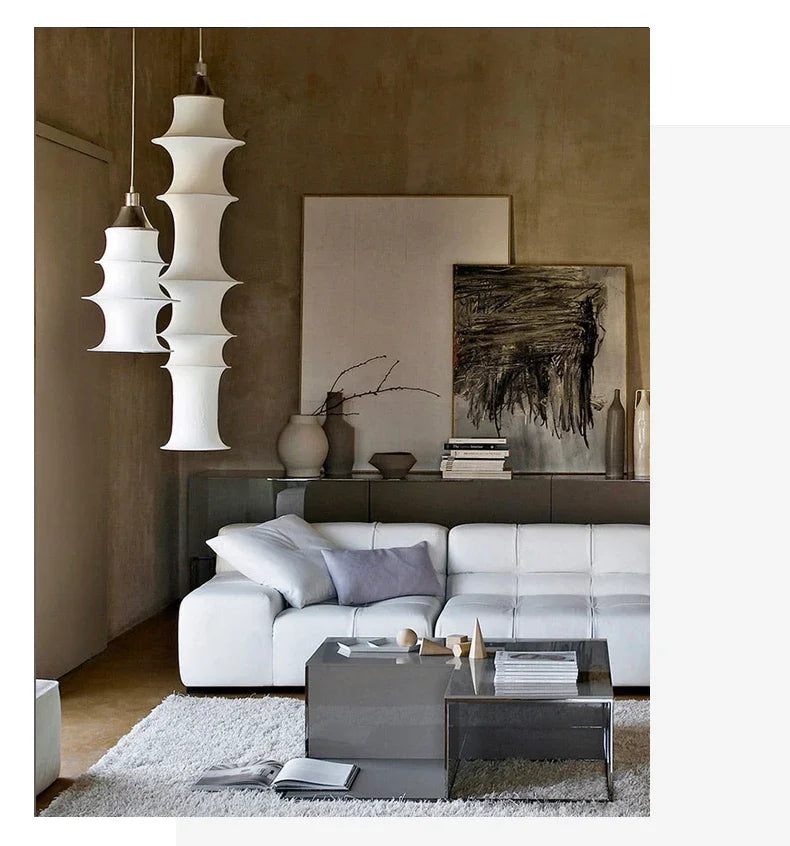 Modern living room with white sofa, coffee table, and abstract art on the wall.