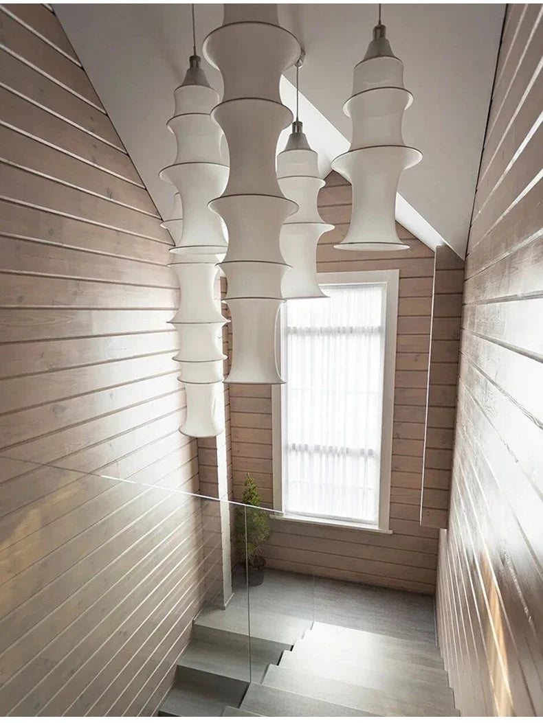 Modern interior with hanging white lamps and wooden walls.