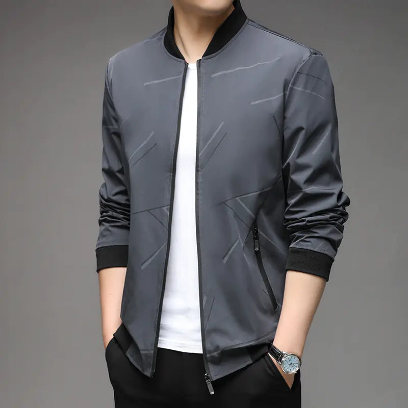 Gray bomber jacket with black accents worn by a person on a gray background