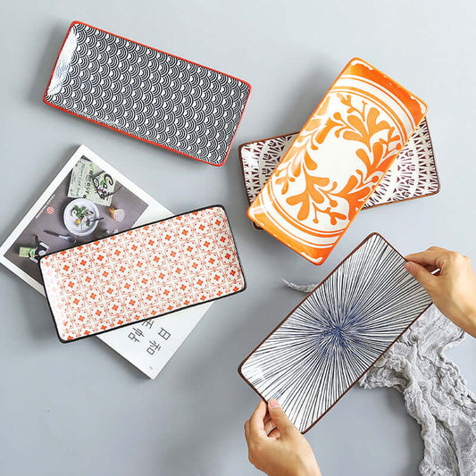 Collection of Nordic Japanese underglaze ceramic small fish plates, showcasing unique patterns and colors.