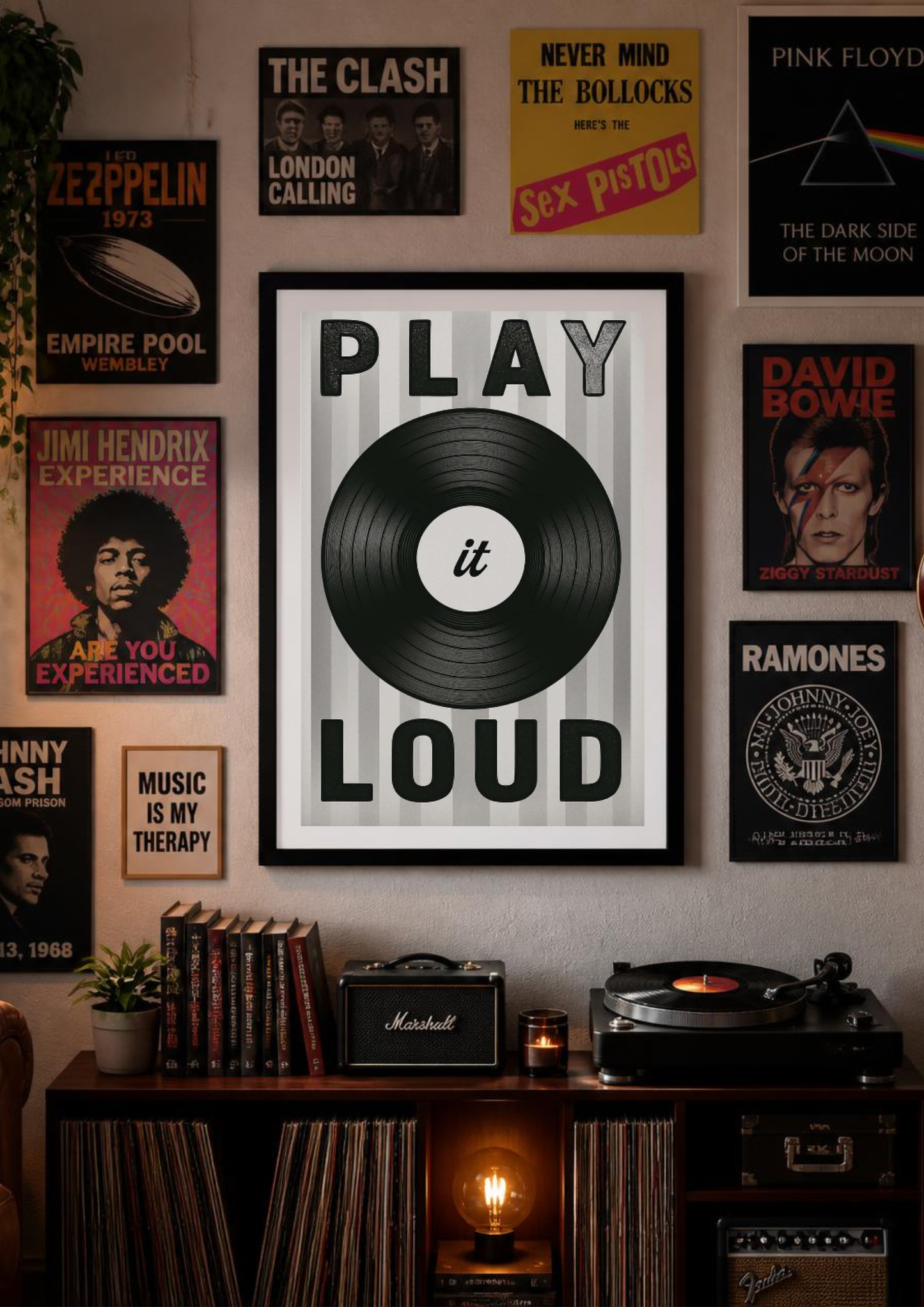 A framed wall poster with the words 'PLAY it LOUD' and a black vinyl record graphic, displayed in a styled music room with other rock and metal posters, a record shelf, and a turntable.