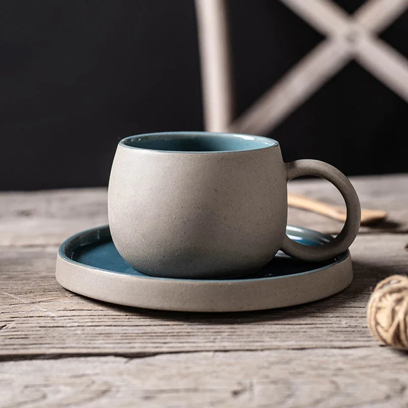 Ceramic mug and saucer set on a wooden surface with a dark background