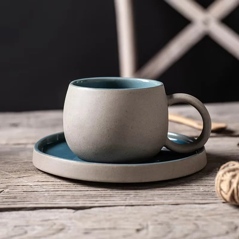Ceramic mug with a matching coaster on a wooden surface