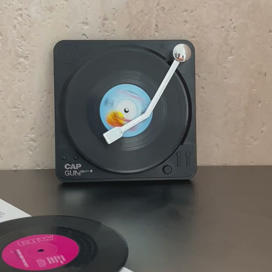 Video of a Set of six black vinyl record coasters with miniature turntable-style storage holder