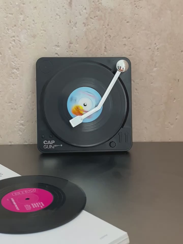 Video of a Set of six black vinyl record coasters with miniature turntable-style storage holder