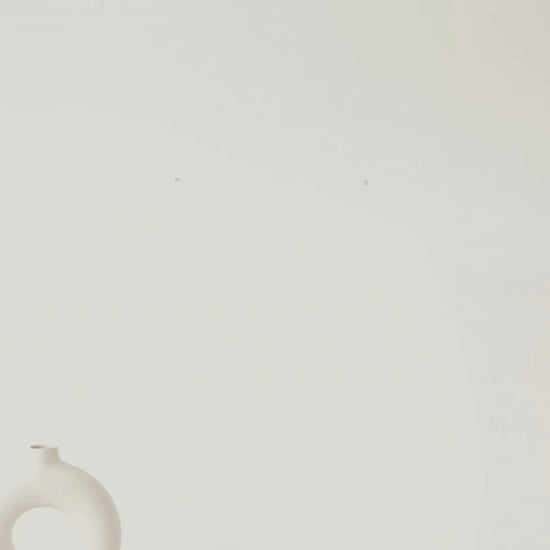 Video of a Minimalist hourglass wall art featuring geometric line work inspired by the science of time on a warm ivory background.