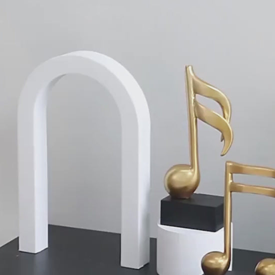 Video of three modern resin musical note sculptures with black bases displayed as contemporary home décor, available in black, white and gold finishes.