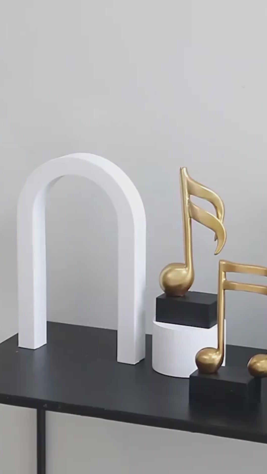 Video of three modern resin musical note sculptures with black bases displayed as contemporary home décor, available in black, white and gold finishes.