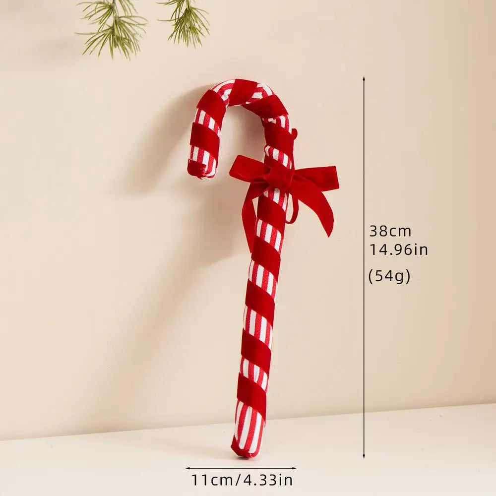 Red and white striped candy cane-shaped toy with a bow on a beige background