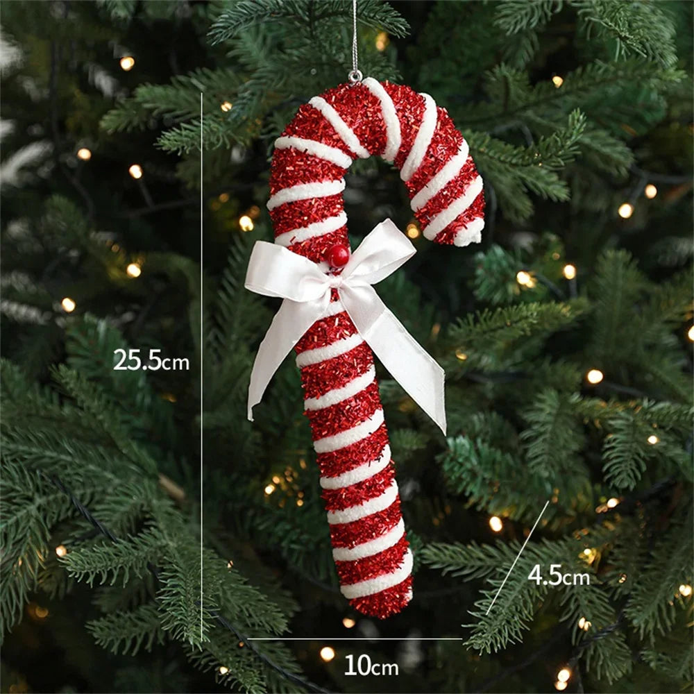 Red and white striped candy cane ornament with a white bow on a Christmas tree, showing measurements.