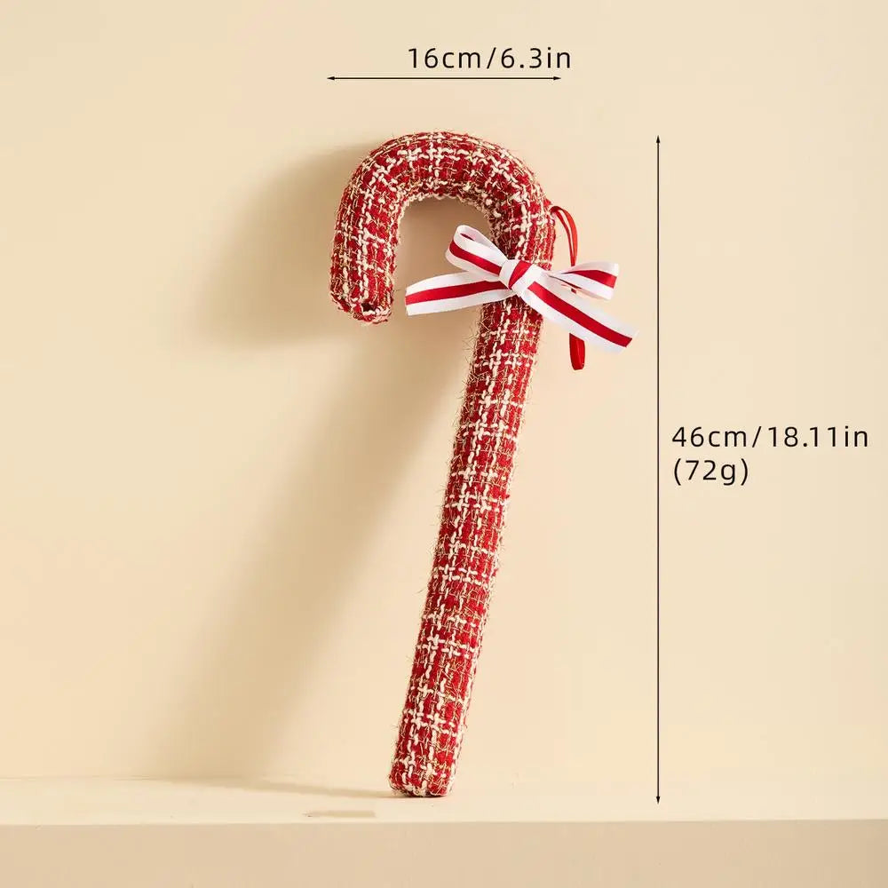 Decorative candy cane with a bow, shown with measurements on a beige background