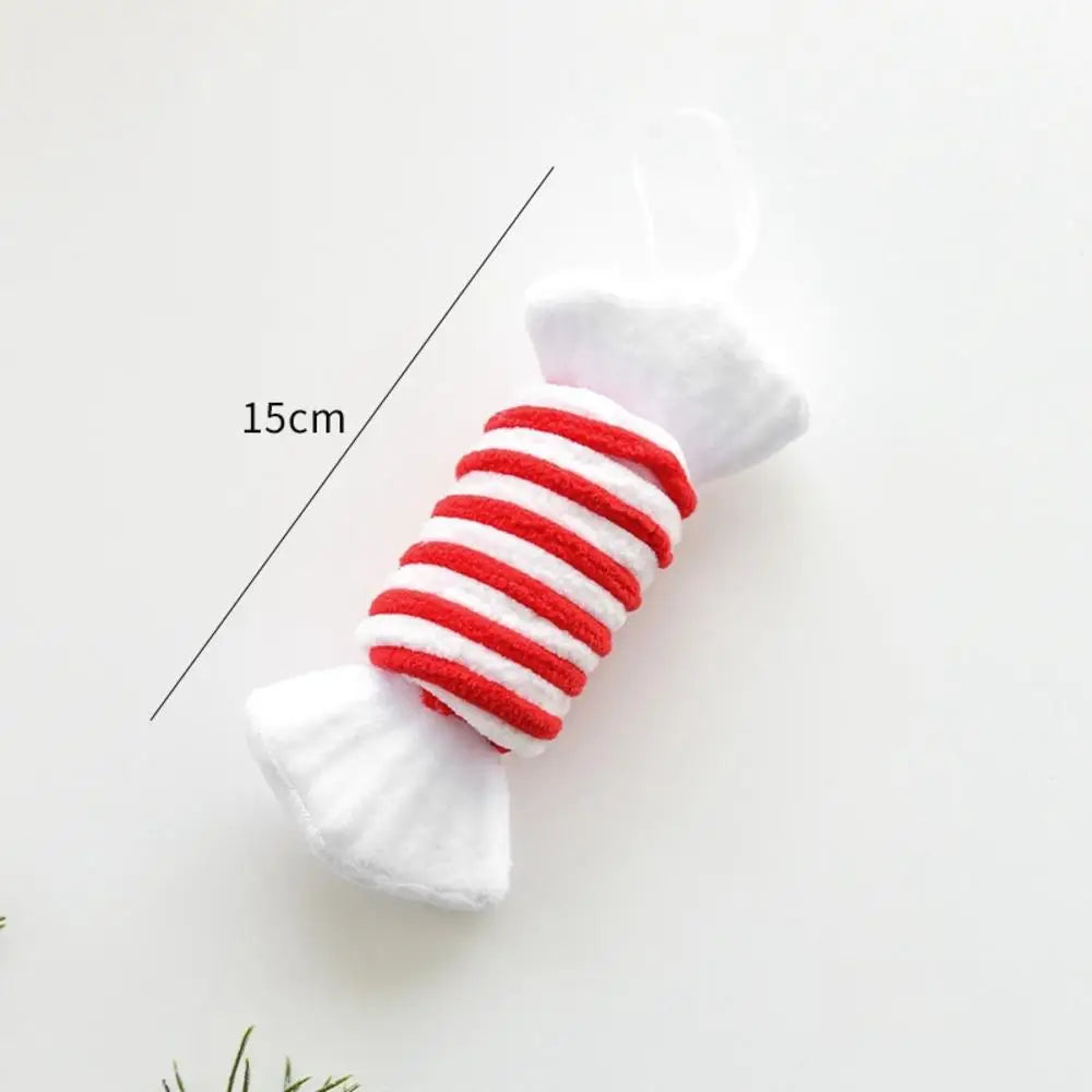 Red and white striped candy-shaped toy with measurement label on a light gray background