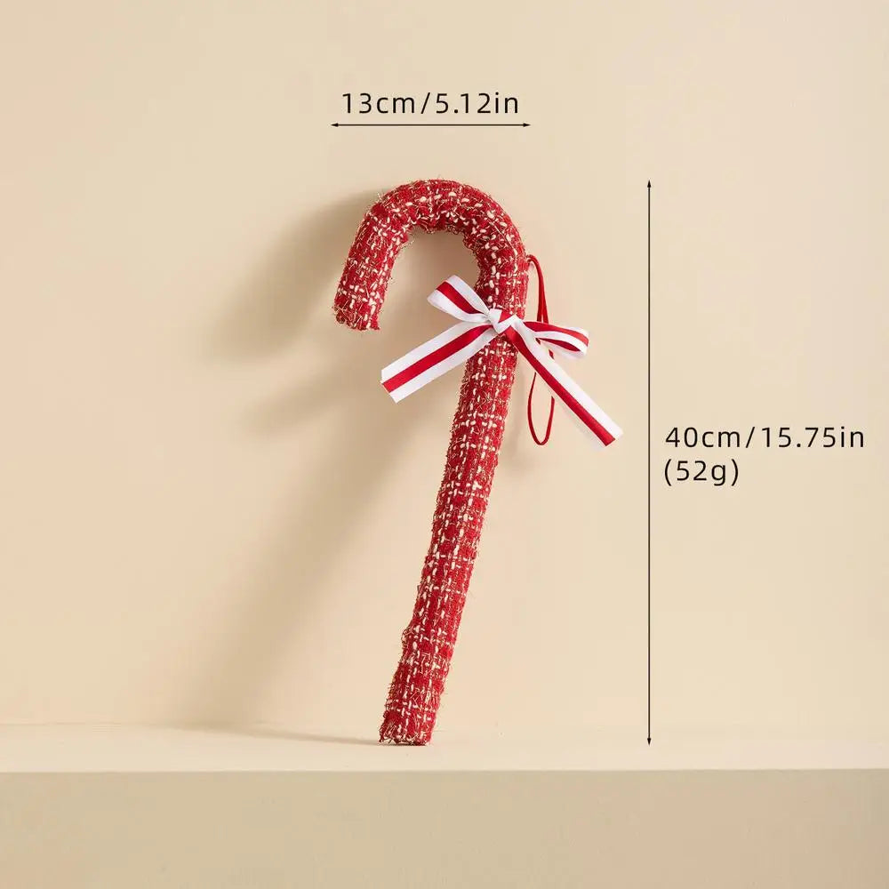 Decorative candy cane with a red and white bow, shown with measurements on a beige background.