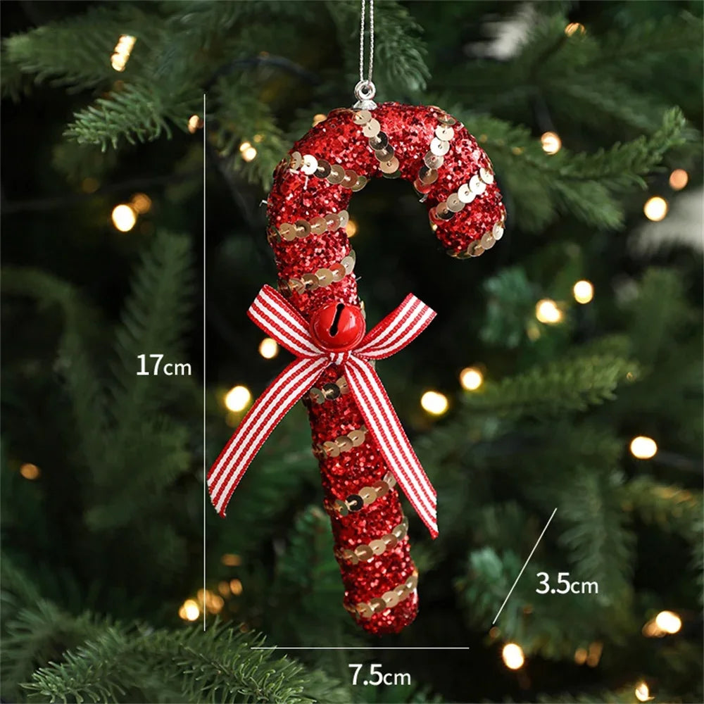 Red glittery candy cane ornament with a bow and bell on a Christmas tree.