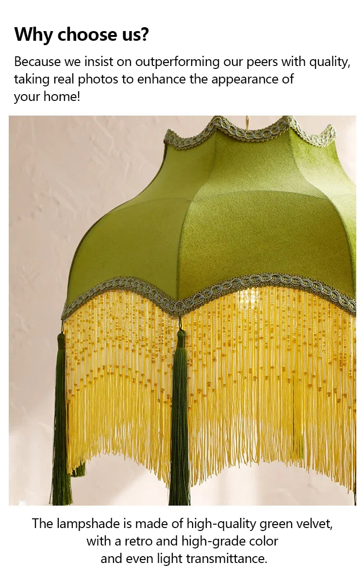 Green lampshade with gold fringe on a light background