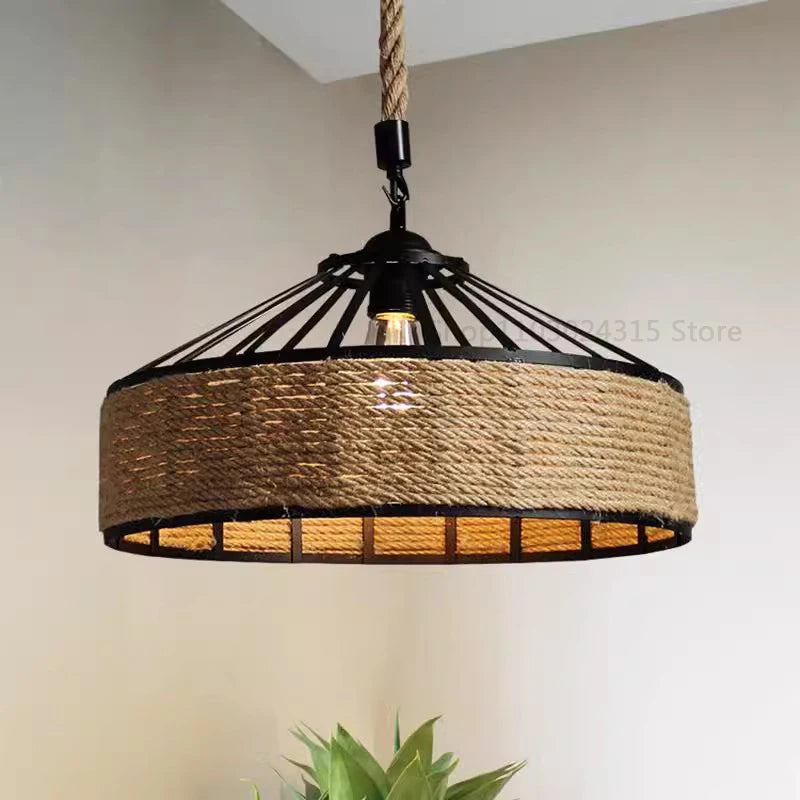 Rustic hemp rope pendant light with industrial metal frame and warm LED bulb, ideal for dining room or café decor.
