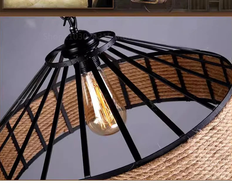 Black metal pendant light with a visible bulb on a neutral background