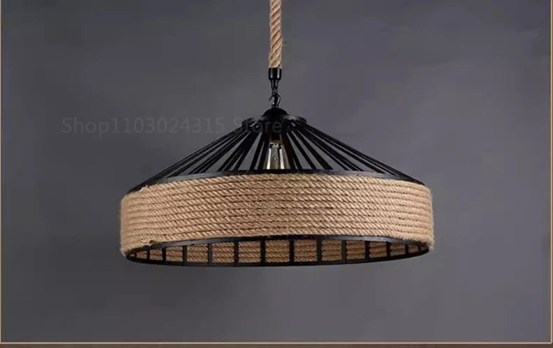 Pendant light with black metal frame and jute rope design on a dark background