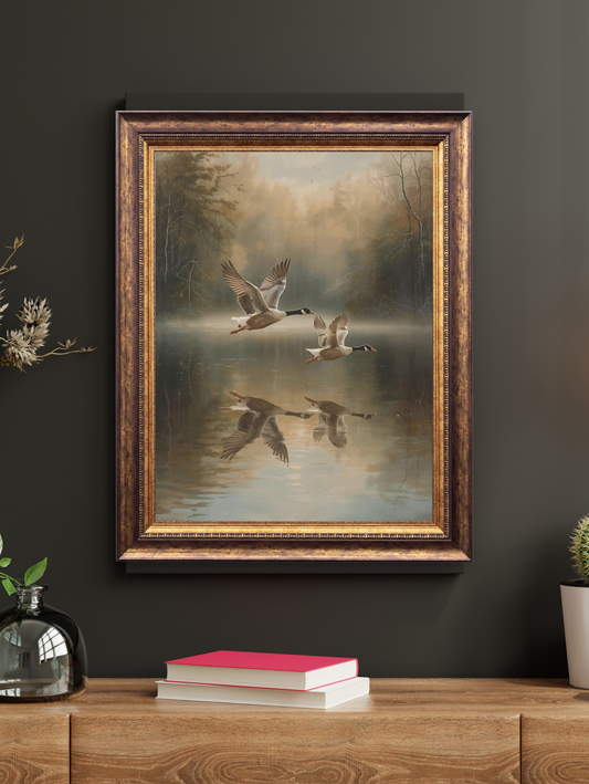 Framed painting of geese over water on a dark wall with decorative elements.