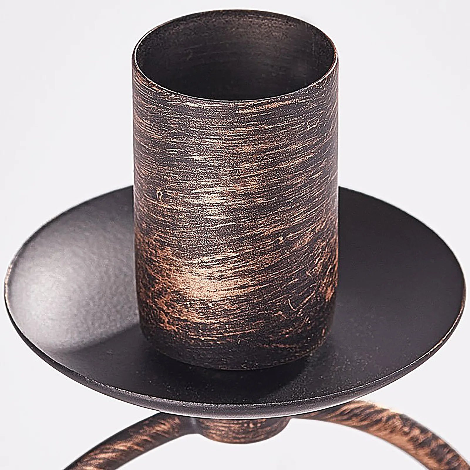 Bronze candle holder with textured design on a white background