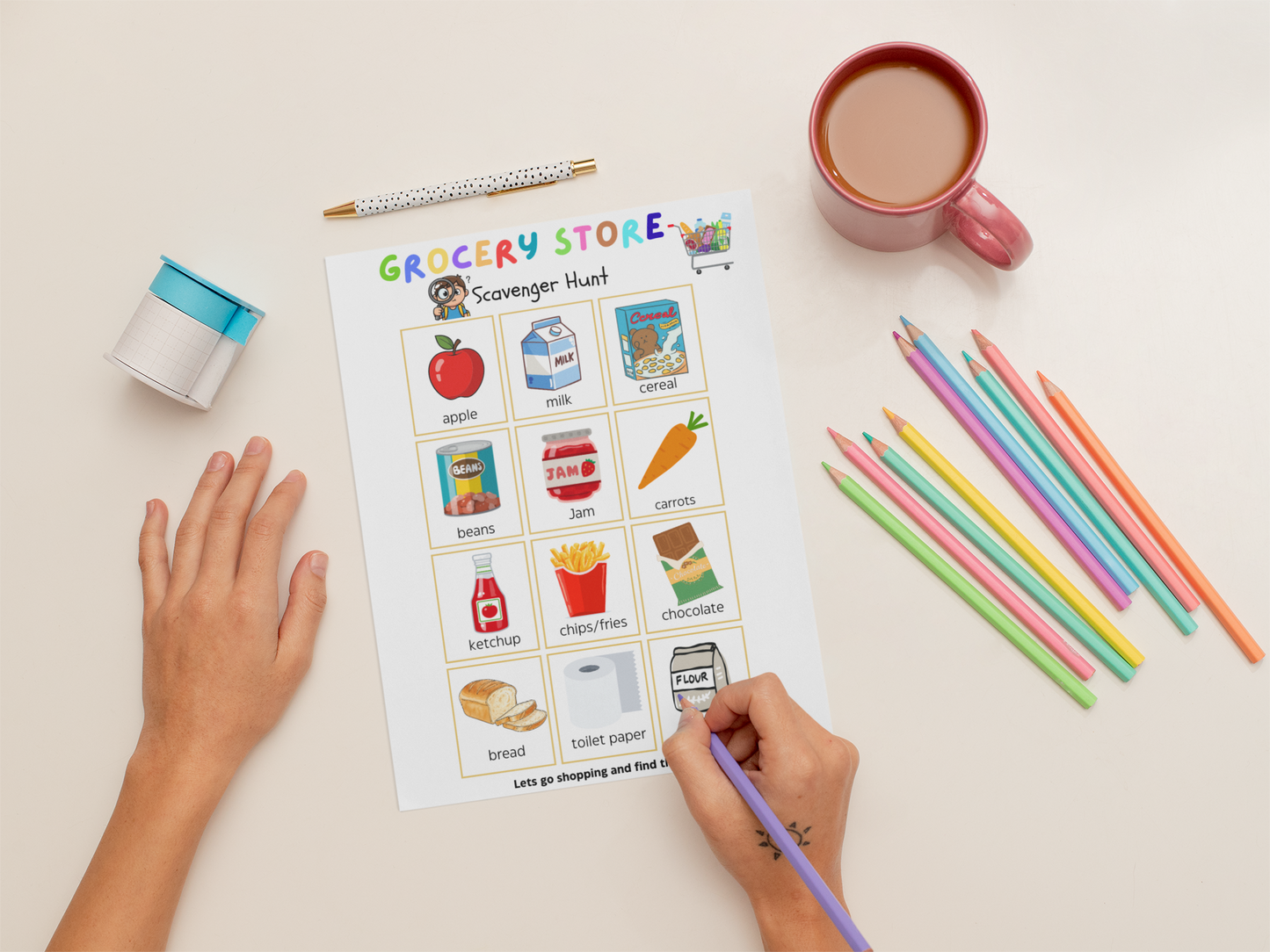 Coloring sheet titled 'Grocery Store Scavenger Hunt' with colored pencils and a mug on a table.