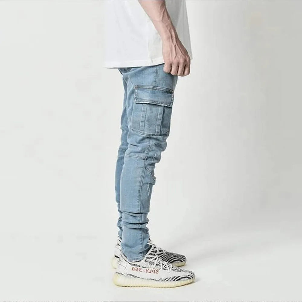 Person wearing light blue cargo jeans and white sneakers on a plain background