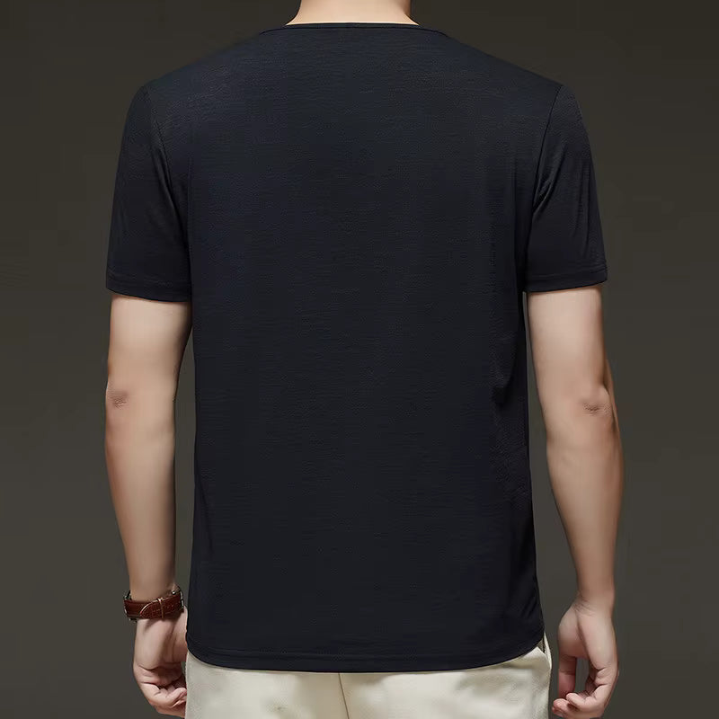 Person wearing a black t-shirt on a dark background