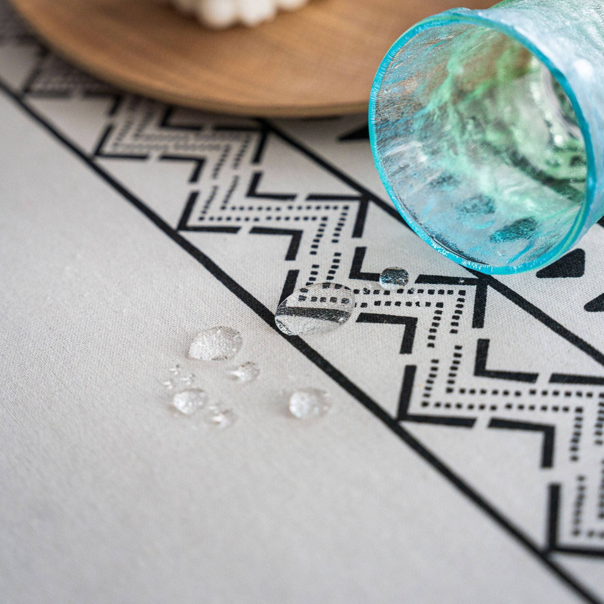 Clear gemstones on a patterned surface with a blue container