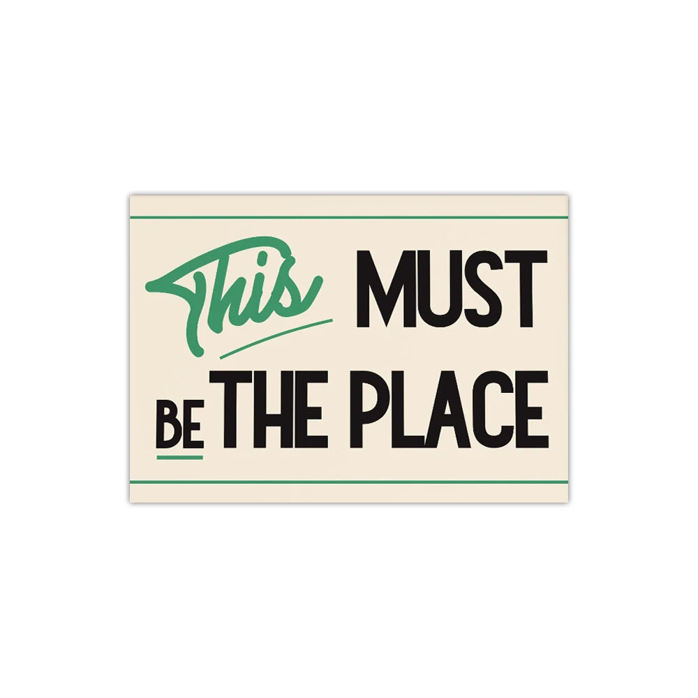 Motivational poster with text 'This Must Be The Place' on a beige background
