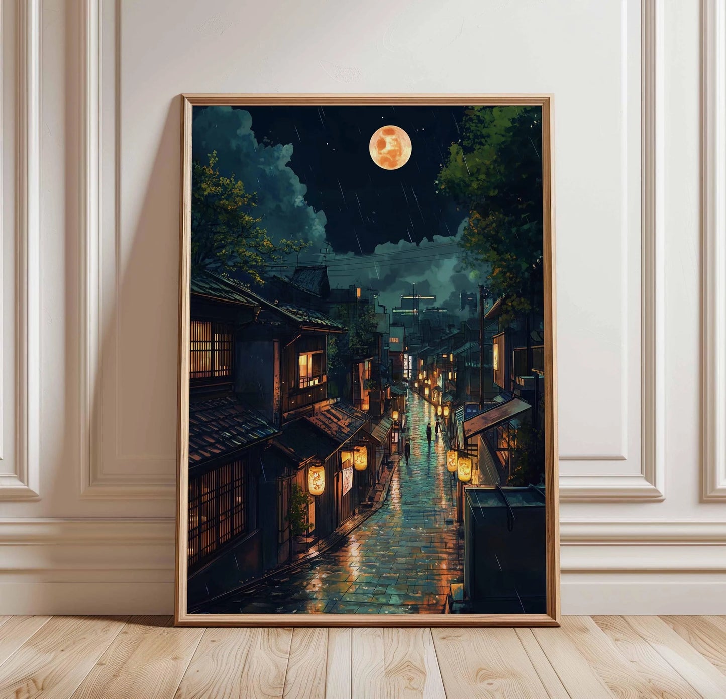 Framed artwork of a moonlit street scene with traditional buildings on a wall.