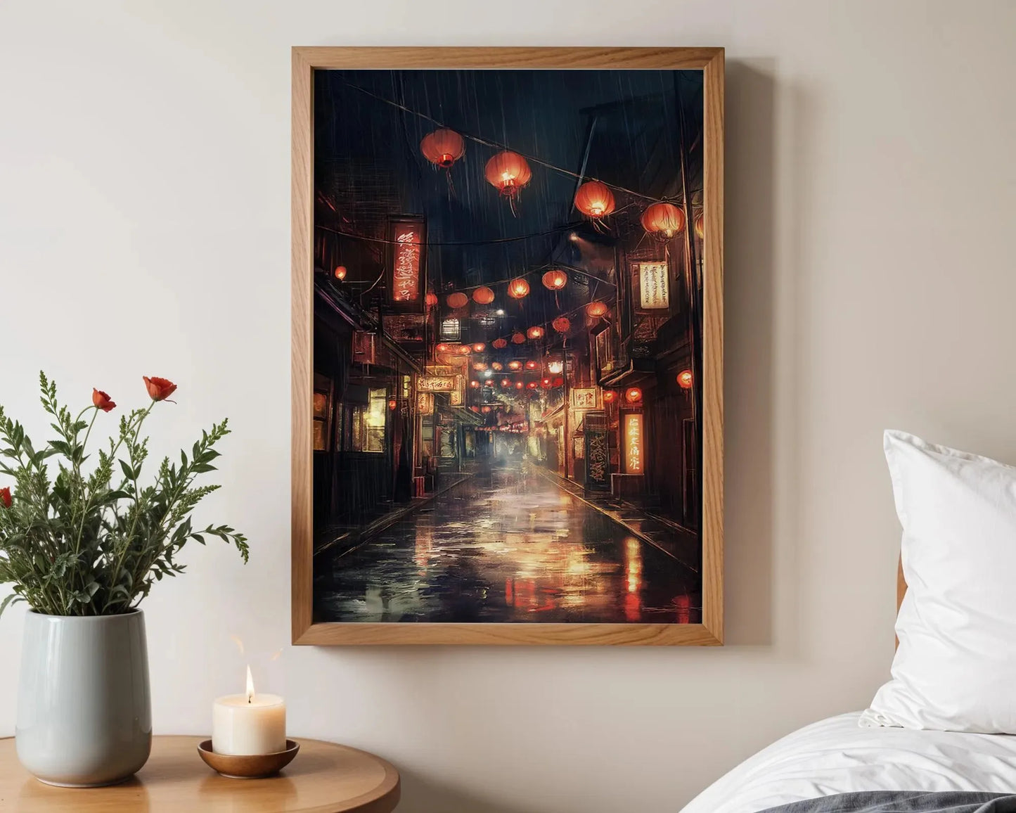 Framed artwork of a street scene with lanterns on a wall above a bed.
