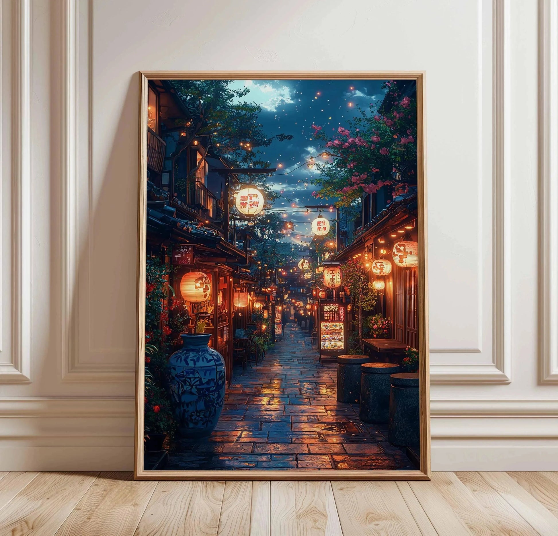 Framed artwork of a night scene with lanterns and flowers on a wall.