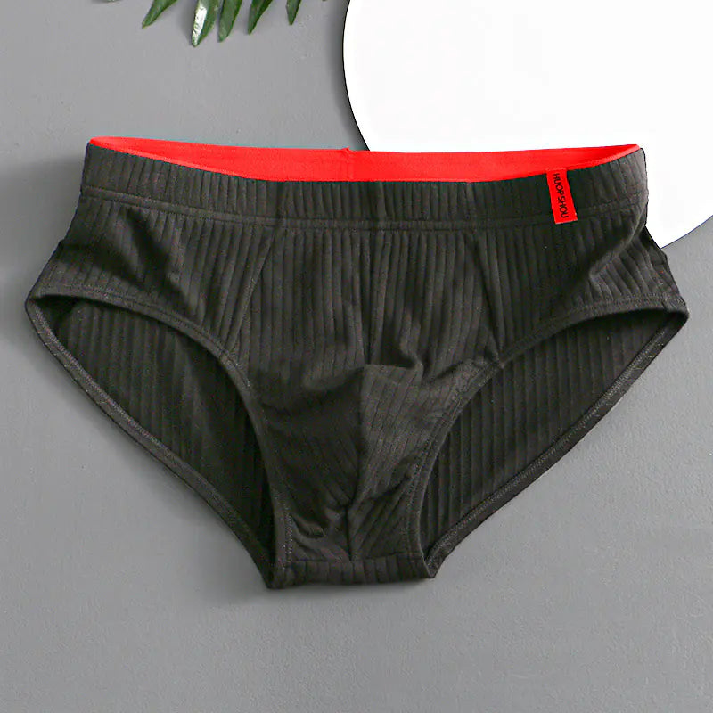 Gray underwear with red waistband on a gray background