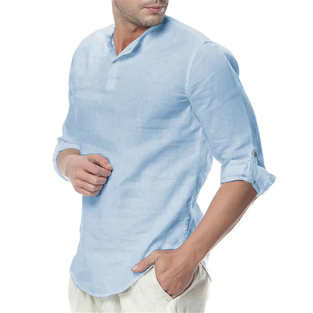 Man wearing a light blue shirt with rolled-up sleeves on a white background