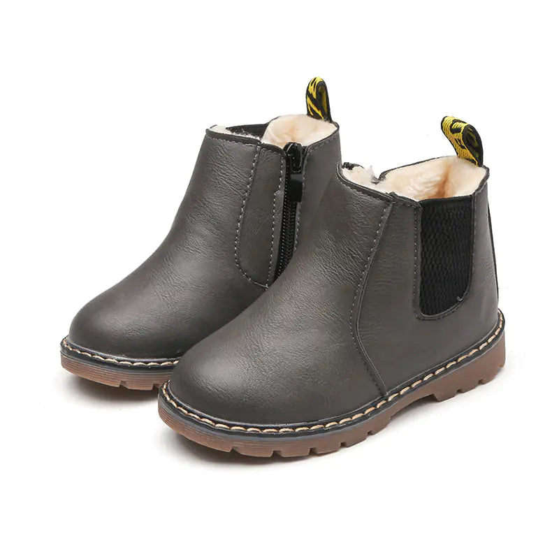 Pair of gray children's boots with fur lining on a white background