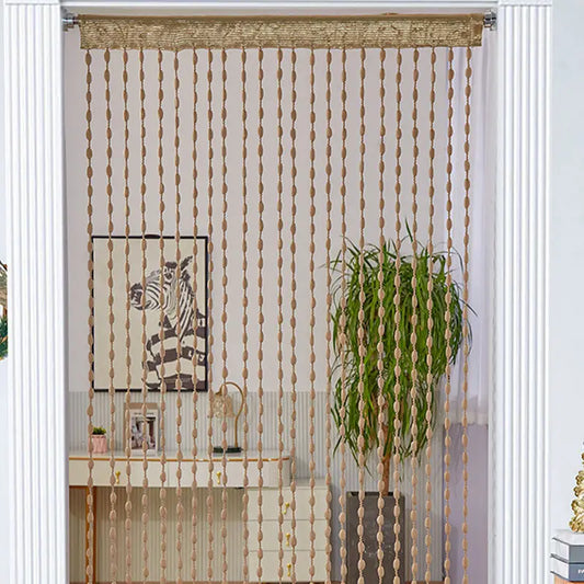 String curtain with decorative beads in a room with a zebra print picture and plant.