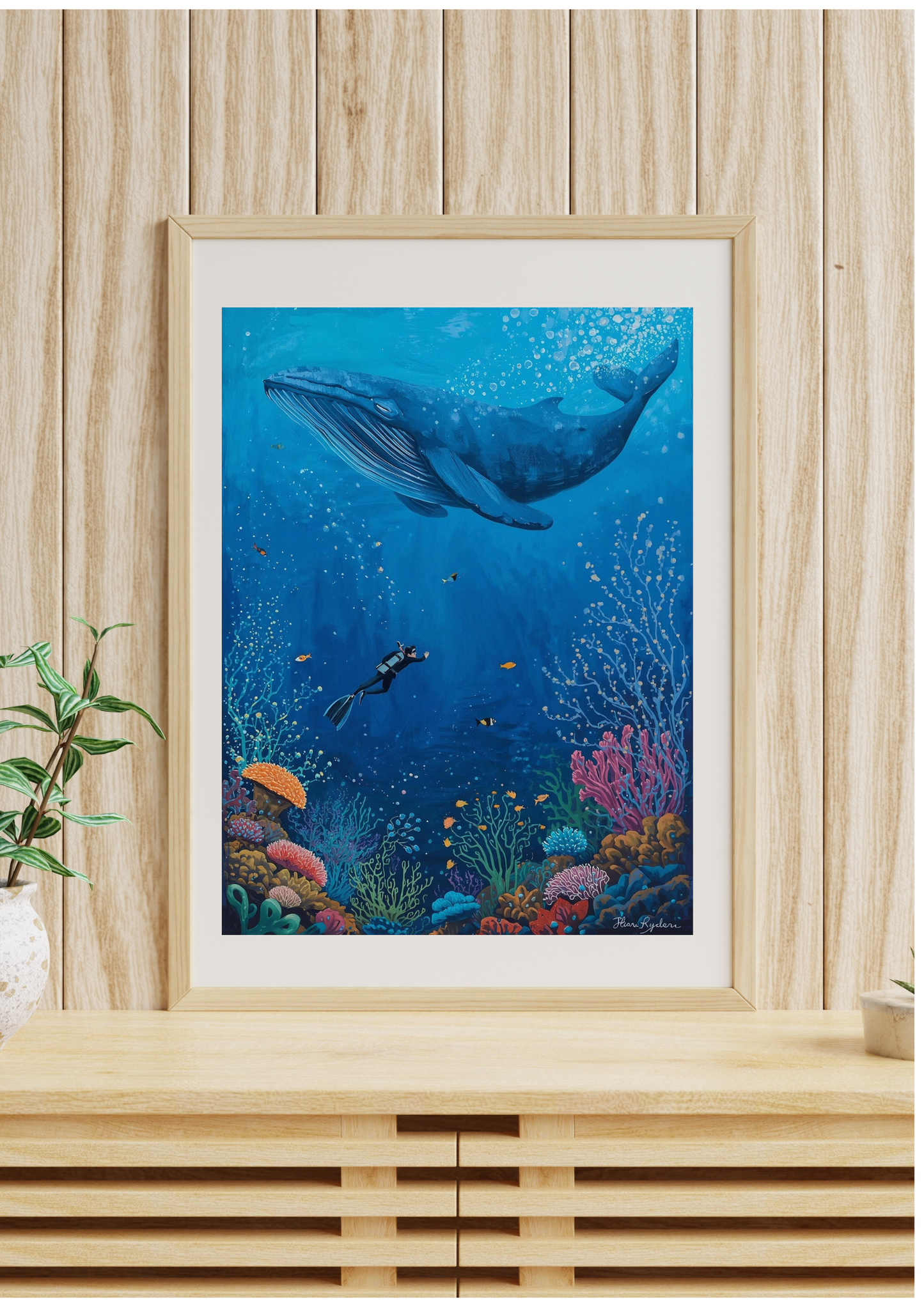 Framed underwater scene with a whale and diver on a wooden wall.