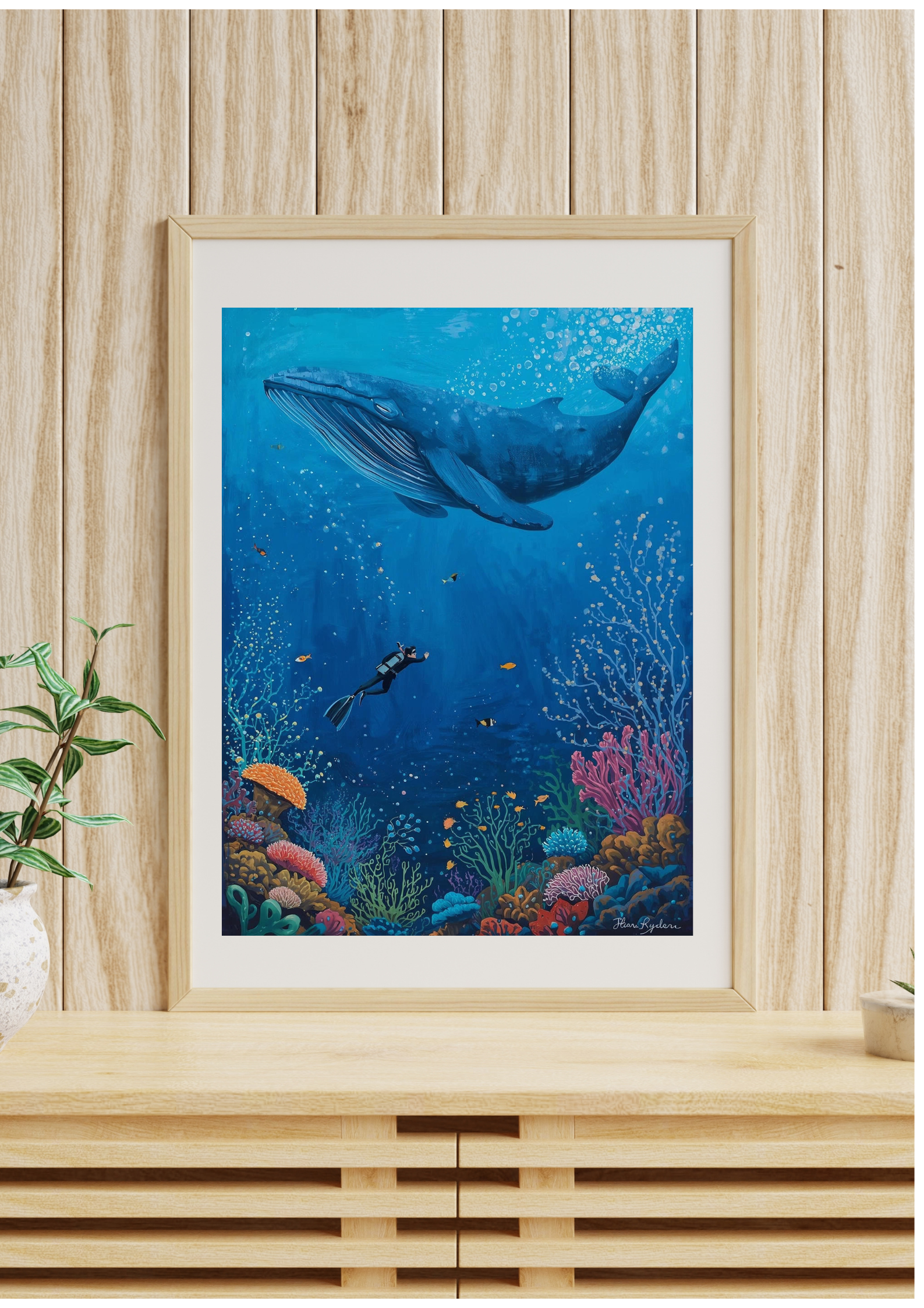 Framed underwater scene with a whale and diver on a wooden wall.