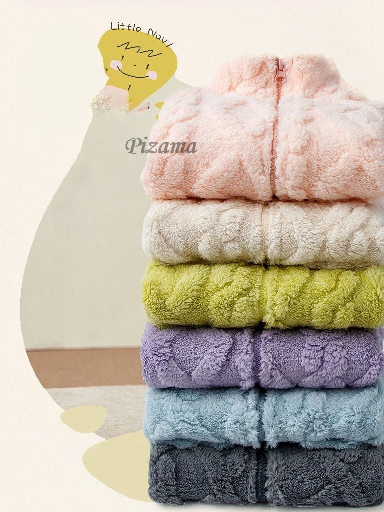 Stack of colorful folded blankets with 'Pizama' branding on a light background