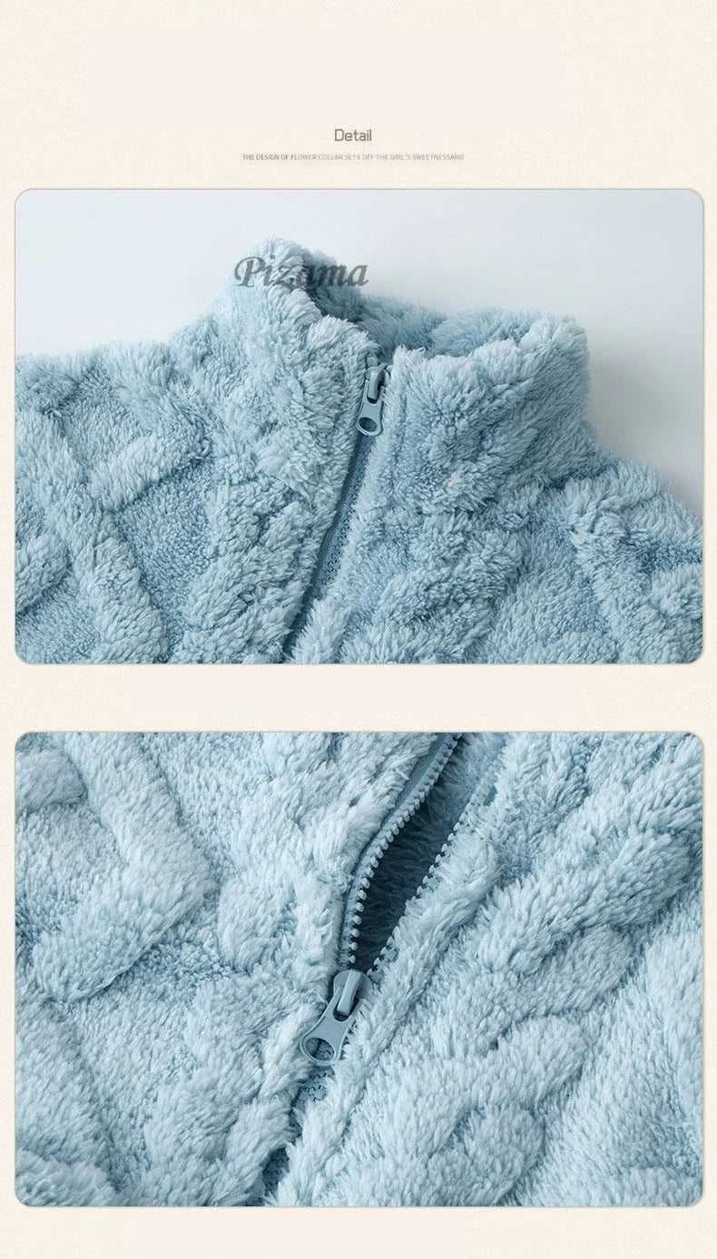 Close-up of a light blue fleece jacket with a zipper on a beige background